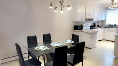 a kitchen and dining room with a table and chairs at Private bedroom in Montréal