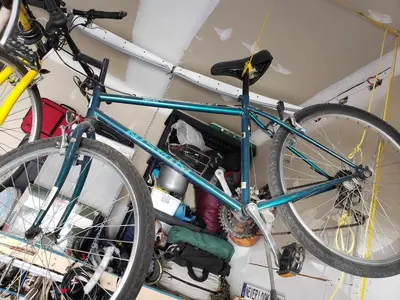 a blue bike is hanging on a wall at La campagne en ville avec spa in Laval