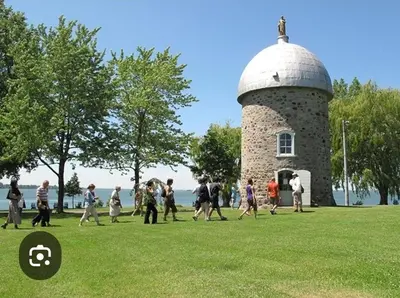 a group of people walking in front of a tower at Luxury bungalow in Châteauguay