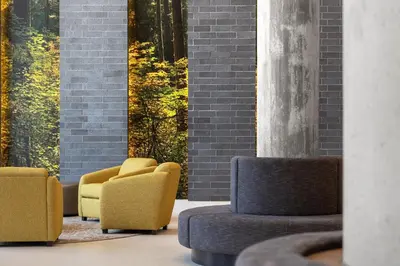 a lobby with two yellow chairs and a table at Staybridge Suites Montreal Airport - St-Laurent by IHG in Montréal