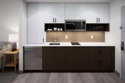 a kitchen with a sink and a microwave at Staybridge Suites Montreal Airport - St-Laurent by IHG in Montréal