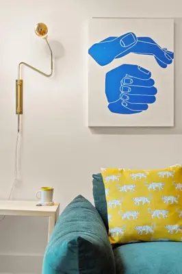 a couch with a yellow pillow next to a lamp at The Slant - Trendy Spot in the Heart of Montreal in Montréal