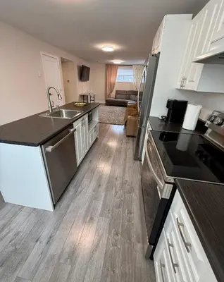 a kitchen with a sink and a counter top at Confort & Harmonie in Longueuil