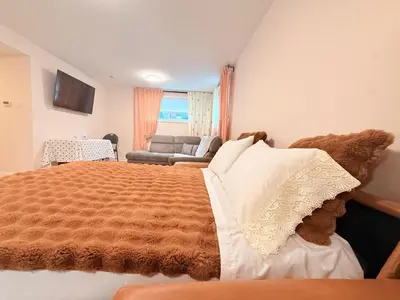 a bedroom with a large bed and a couch at Confort & Harmonie in Longueuil