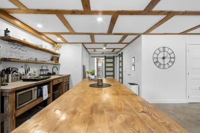 a large kitchen with a large wooden counter top at Le nid des hirondelles in Windsor