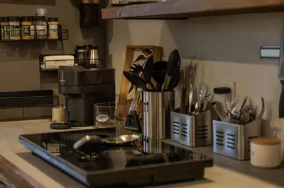 a kitchen counter with a stove and utensils at Le nid des hirondelles in Windsor