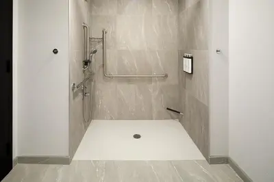 a bathroom with a shower with a shower curtain at Hyatt Place Montreal Airport in Dorval