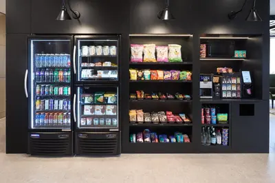 a black refrigerator with lots of food and drinks at Hyatt Place Montreal Airport in Dorval