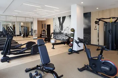 a gym with several treadmills and exercise bikes at Hyatt Place Montreal Airport in Dorval