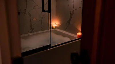 a bathroom with a tub with candles and a mirror at Spacious two stories condo in old port free parking in Montréal
