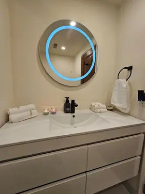 a bathroom with a white sink and a mirror at Spacious two stories condo in old port free parking in Montréal