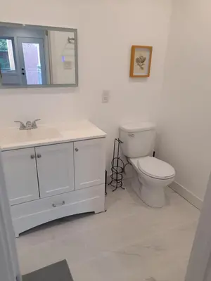 a bathroom with a toilet and a sink and a mirror at Bedford 2 in Montréal