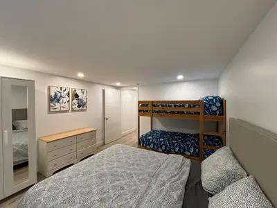 a bedroom with two bunk beds and a desk at Bedford 2 in Montréal