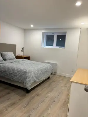 a bedroom with a bed and a window at Bedford 2 in Montréal