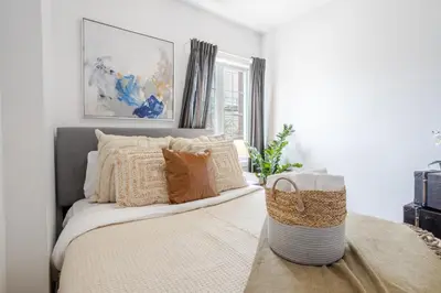 a bedroom with a bed with pillows on it at Stylish 3BR in Griffintown in Montréal