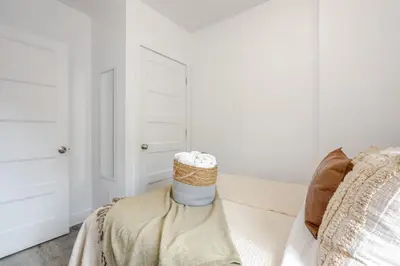 a bedroom with a bed with a basket on it at Stylish 3BR in Griffintown in Montréal