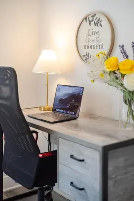 an office with a desk with a laptop computer on it at Fashionable 3BR in Griffintown in Montréal