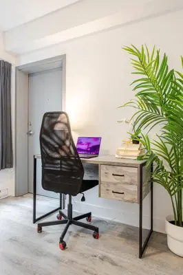 an office with a desk with a laptop computer on it at Fashionable 3BR in Griffintown in Montréal