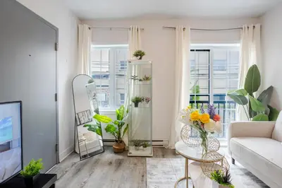 a living room with a couch and some plants at Fashionable 3BR in Griffintown in Montréal