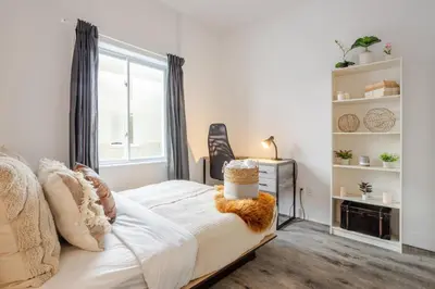 a bedroom with a white bed and a window at Chic and Spacious 3 Bedrooms in Griffintown in Montréal