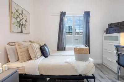 a bedroom with a bed and a window at Chic and Spacious 3 Bedrooms in Griffintown in Montréal
