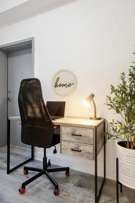an office with a desk with a chair and a laptop at Chic and Spacious 3 Bedrooms in Griffintown in Montréal