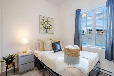 a bedroom with a bed and a window at Chic and Spacious 3 Bedrooms in Griffintown in Montréal