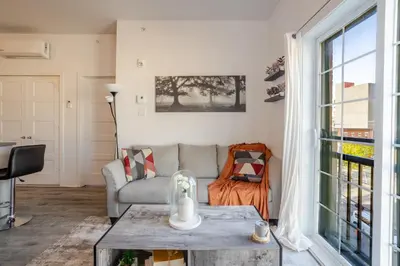 a living room with a couch and a table at Bright and Beautiful 3 Bedroom in Griffintown in Montréal