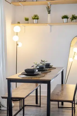 a dining room table with bowls and plants on it at Bright and Beautiful 3 Bedroom in Griffintown in Montréal