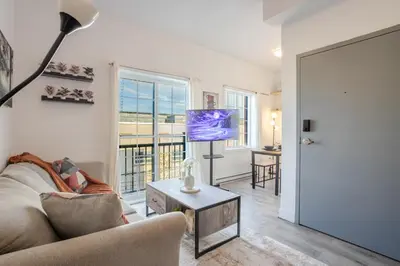 a living room with a couch and a table at Bright and Beautiful 3 Bedroom in Griffintown in Montréal