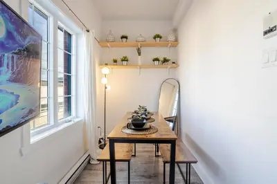 a small hallway with a table and a window at Bright and Beautiful 3 Bedroom in Griffintown in Montréal