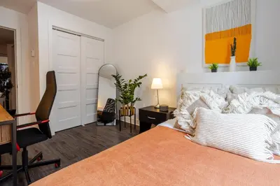 a bedroom with a bed and a desk and a chair at Cozy and Spacious Condo Downtown in Montréal