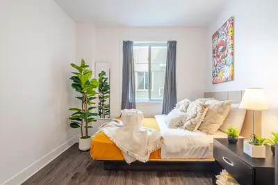 a living room with a couch and a window at Cozy and Spacious Condo Downtown in Montréal