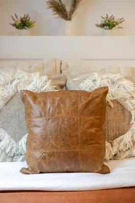 a brown leather pillow sitting on top of a couch at Cozy and Spacious Condo Downtown in Montréal
