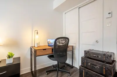a room with a desk with a computer and a chair at Cozy and Spacious Condo Downtown in Montréal