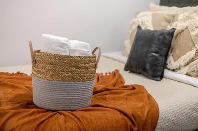 a basket of towels sitting on top of a bed at Amazing 4 Bedroom Unit in Downtown in Montréal