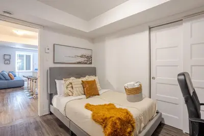 a bedroom with a bed and a door at Amazing 4 Bedroom Unit in Downtown in Montréal