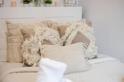 a pile of pillows on a couch in a living room at Modern Apartment in the Heart of Griffintown in Montréal