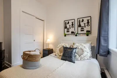 a bedroom with a bed with a basket on it at Modern Apartment in the Heart of Griffintown in Montréal