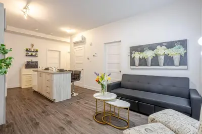 a living room with a couch and a table at Modern Apartment in the Heart of Griffintown in Montréal