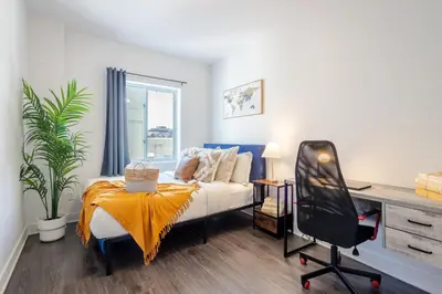 a bedroom with a bed and a desk at Wonderful 4 BR Home in the heart of Downtown in Montréal