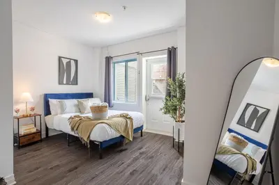 a bedroom with a bed and a mirror at Luxurious 4 BR Suite in Griffintown in Montréal