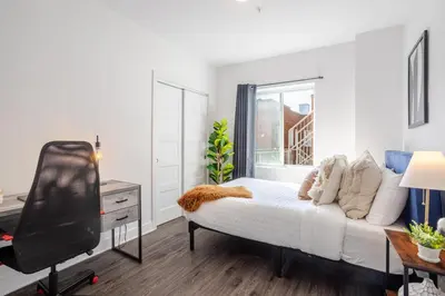 a bedroom with a bed and a tv in it at Luxurious 4 BR Suite in Griffintown in Montréal