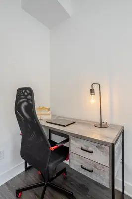 an office with a desk with a black chair at Luxurious 4 BR Suite in Griffintown in Montréal