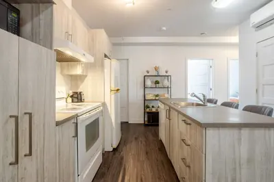 a kitchen with a sink and a counter top at Luxurious 4 BR Suite in Griffintown in Montréal