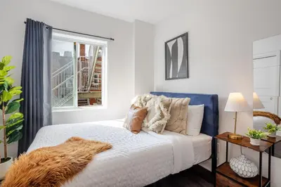 a bedroom with a bed and a window at Luxurious 4 BR Suite in Griffintown in Montréal