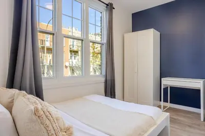 a bedroom with a bed and a window at Warm 2BR in the Heart of Plateau MTL in Montréal