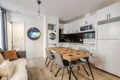 a kitchen and dining room with a table and chairs at Warm 2BR in the Heart of Plateau MTL in Montréal