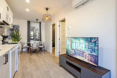 a living room with a large flat screen tv at The Perfect Downtown Hideaway in Montréal