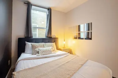 a bedroom with a bed and a window at The Perfect Downtown Hideaway in Montréal